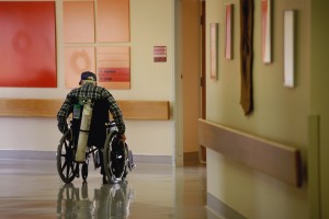 assisted living hallway man in wheelchair