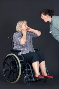 Mean caregiver yelling at elderly woman in wheelchair