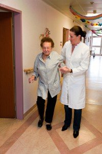 caregiver assisting patient walking