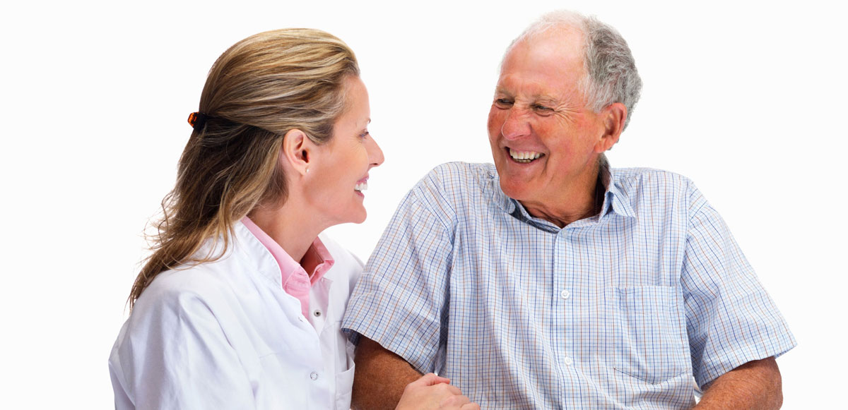 nurse and elder man smiling in a dementia care and assisted living facilities