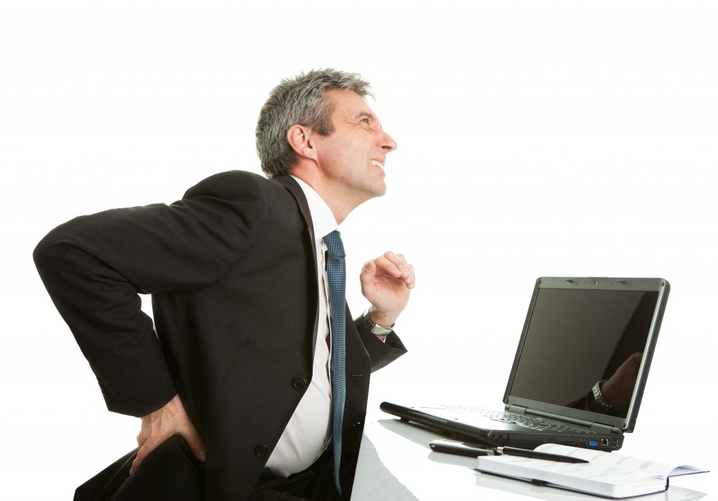 man at computer desk with arthritis