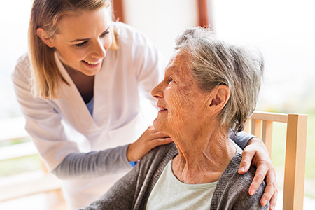 Care Services helping elderly woman smiles