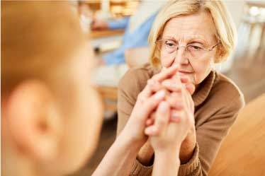 Concerned woman holding moms hand