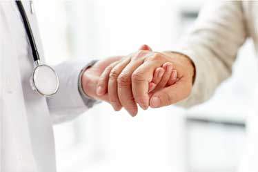 Doctor holding his dementia patients hand