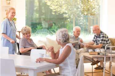 Assisted Living Nurse helping Senior Men and Women in Great Room