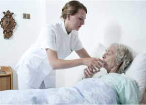 Respite Care Nurse giving water to elderly woman